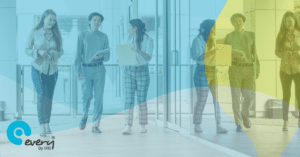 Three members of school staff walking down a corridor.