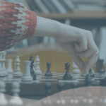 Section of a chess board with a player moving a white piece into a new position. An Every HR By IRIS gradient overlays the image.