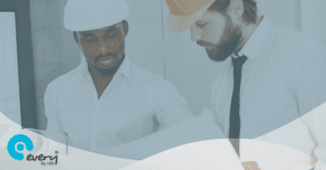 2 men wearing protective hats looking down at a piece of paper. An Every Compliance By IRIS gradient overlays the image.